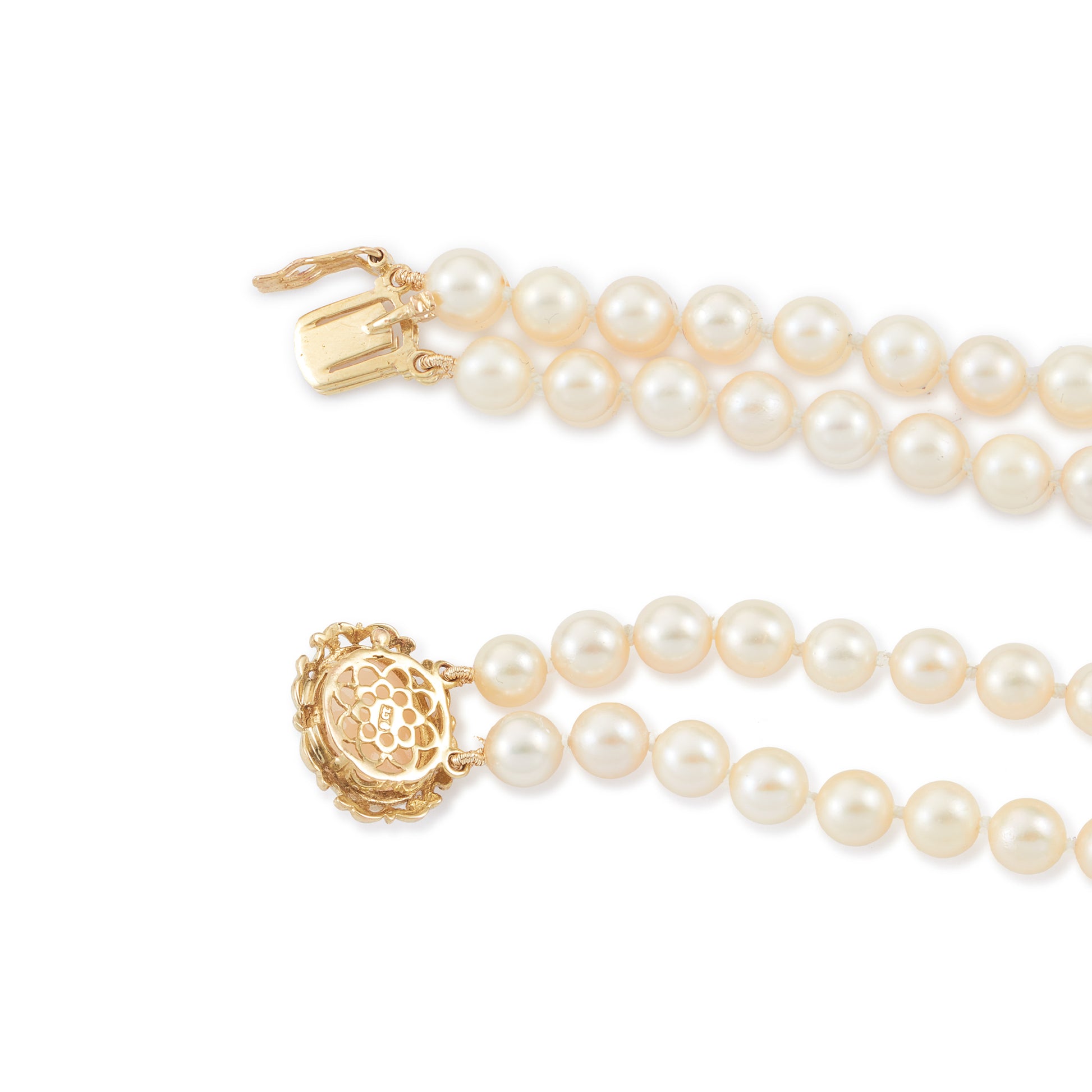 Lovely double strand bracelet consisting of lustrous cultured seawater pearls attached to a 9ct yellow gold and milky chalcedony clasp.