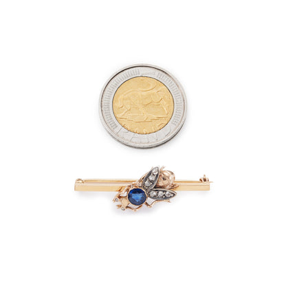 Charming 15ct yellow gold bar brooch featuring a quaint insect with a sapphire body and mine cut diamond eyes and wings.