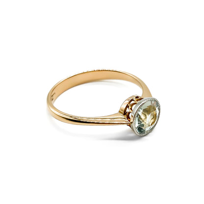 Stunning Edwardian rose gold ring with a round faceted sea blue aquamarine in a white and rose gold setting.