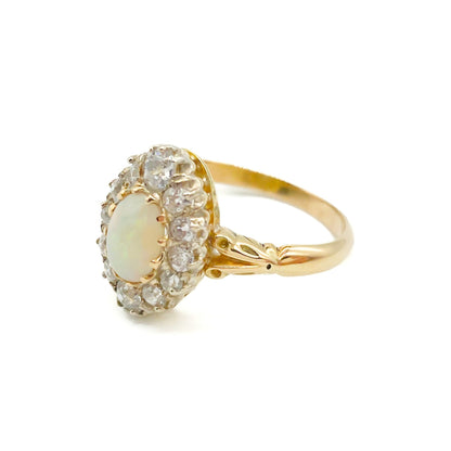 Beautiful Edwardian 18ct yellow gold ring set with an oval opal cabochon surrounded by twelve old-European-cut diamonds.