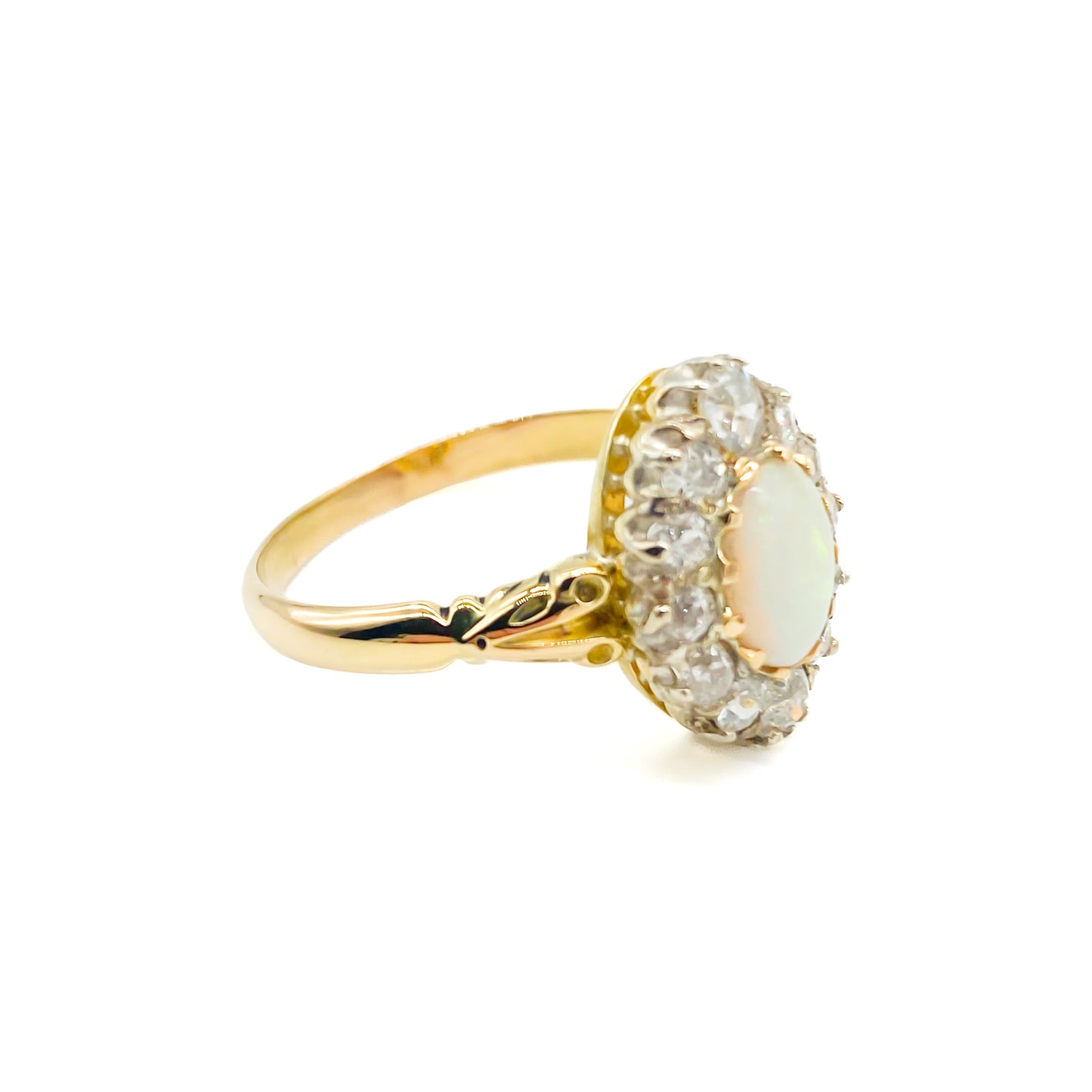 Beautiful Edwardian 18ct yellow gold ring set with an oval opal cabochon surrounded by twelve old-European-cut diamonds.