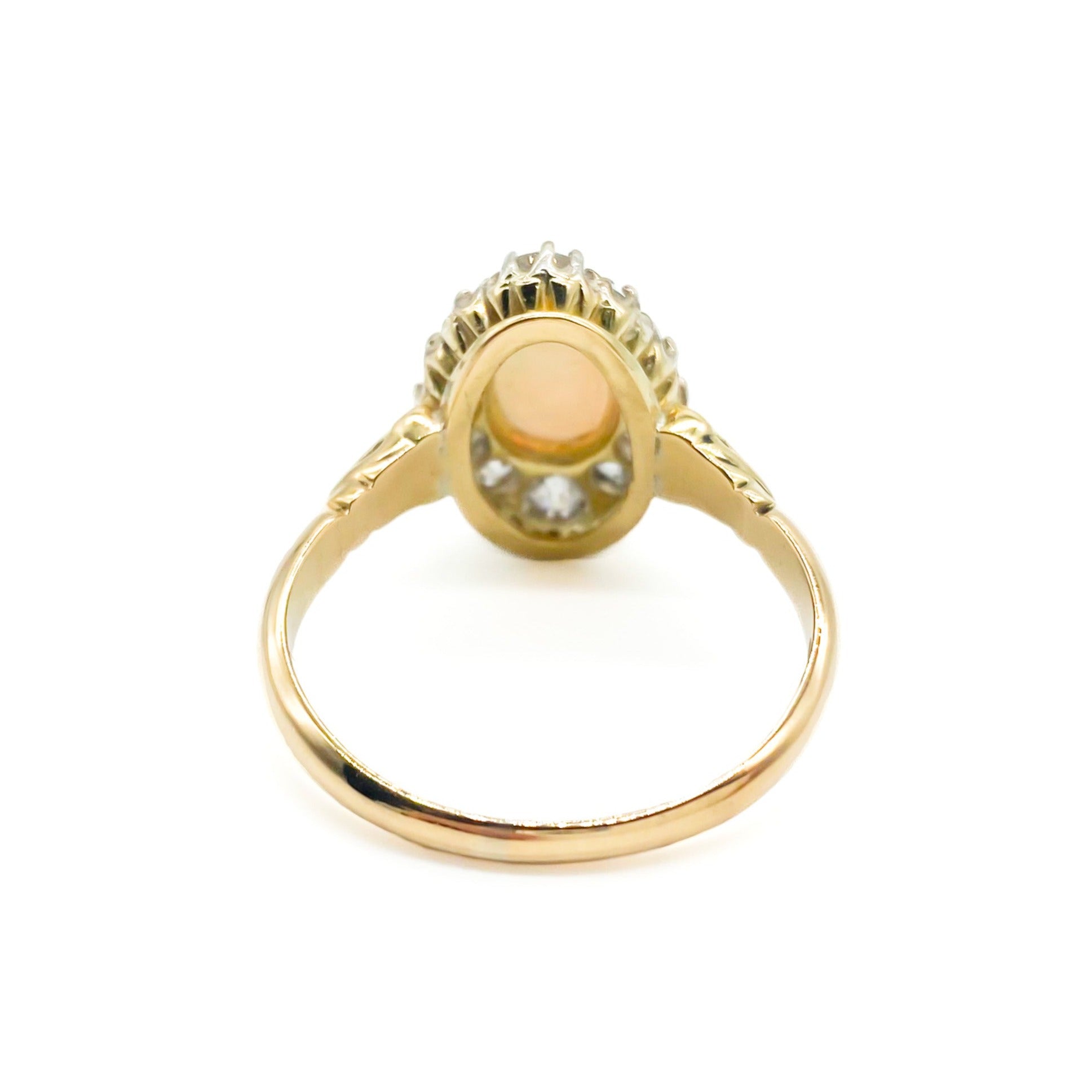 Beautiful Edwardian 18ct yellow gold ring set with an oval opal cabochon surrounded by twelve old-European-cut diamonds.