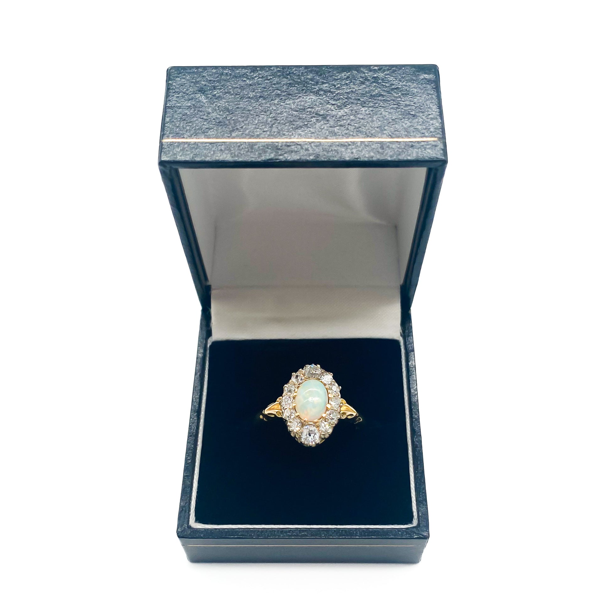 Beautiful Edwardian 18ct yellow gold ring set with an oval opal cabochon surrounded by twelve old-European-cut diamonds.