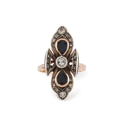 Gorgeous Edwardian 18ct rose gold and silver ring set with three round old-European-cut diamonds, two teardrop sapphires and eighteen smaller mine-cut diamond chips. The centre old-cut diamond has a natural inclusion that adds character to the piece.