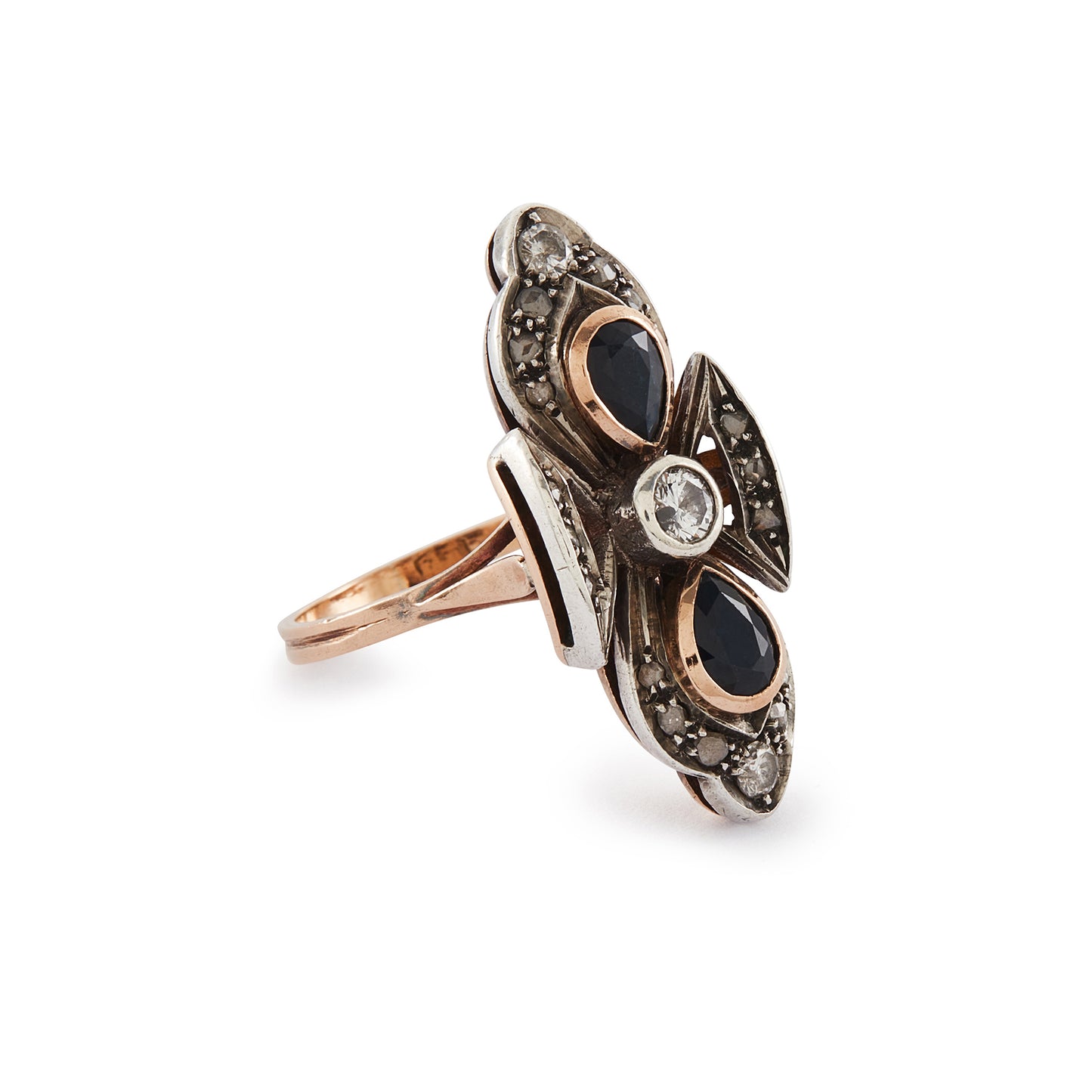Gorgeous Edwardian 18ct rose gold and silver ring set with three round old-European-cut diamonds, two teardrop sapphires and eighteen smaller mine-cut diamond chips. The centre old-cut diamond has a natural inclusion that adds character to the piece.