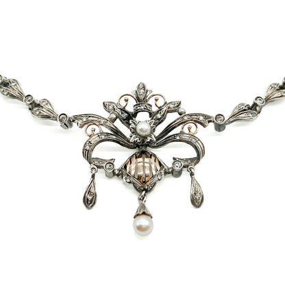 Intricate Edwardian 18ct gold and silver festoon necklace set with two cultured pearls and a variety of paste stones.