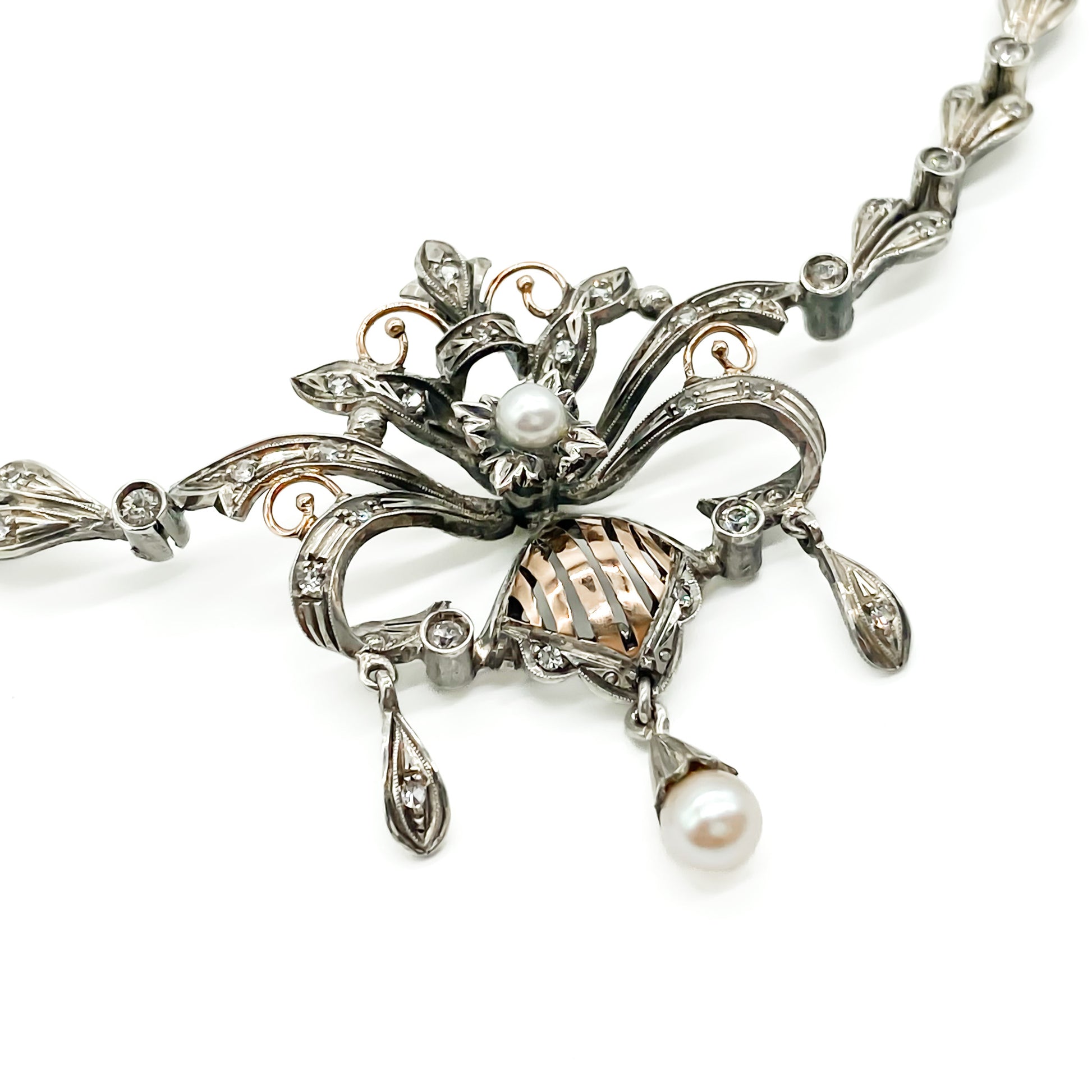 Intricate Edwardian 18ct gold and silver festoon necklace set with two cultured pearls and a variety of paste stones.