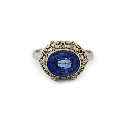 Stunning Edwardian 18ct white gold ring, set with a cornflower blue sapphire in an ornate setting, embellished by six tiny mine cut diamonds.