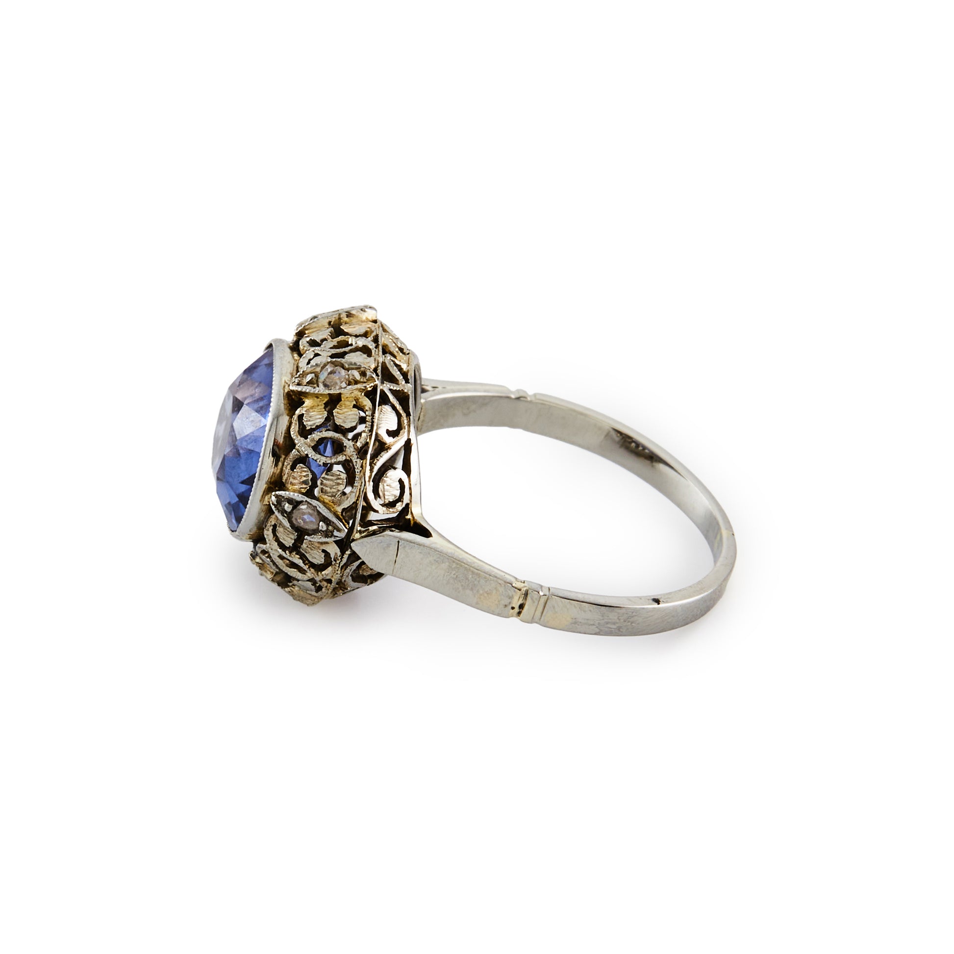 Stunning Edwardian 18ct white gold ring, set with a cornflower blue sapphire in an ornate setting, embellished by six tiny mine cut diamonds.