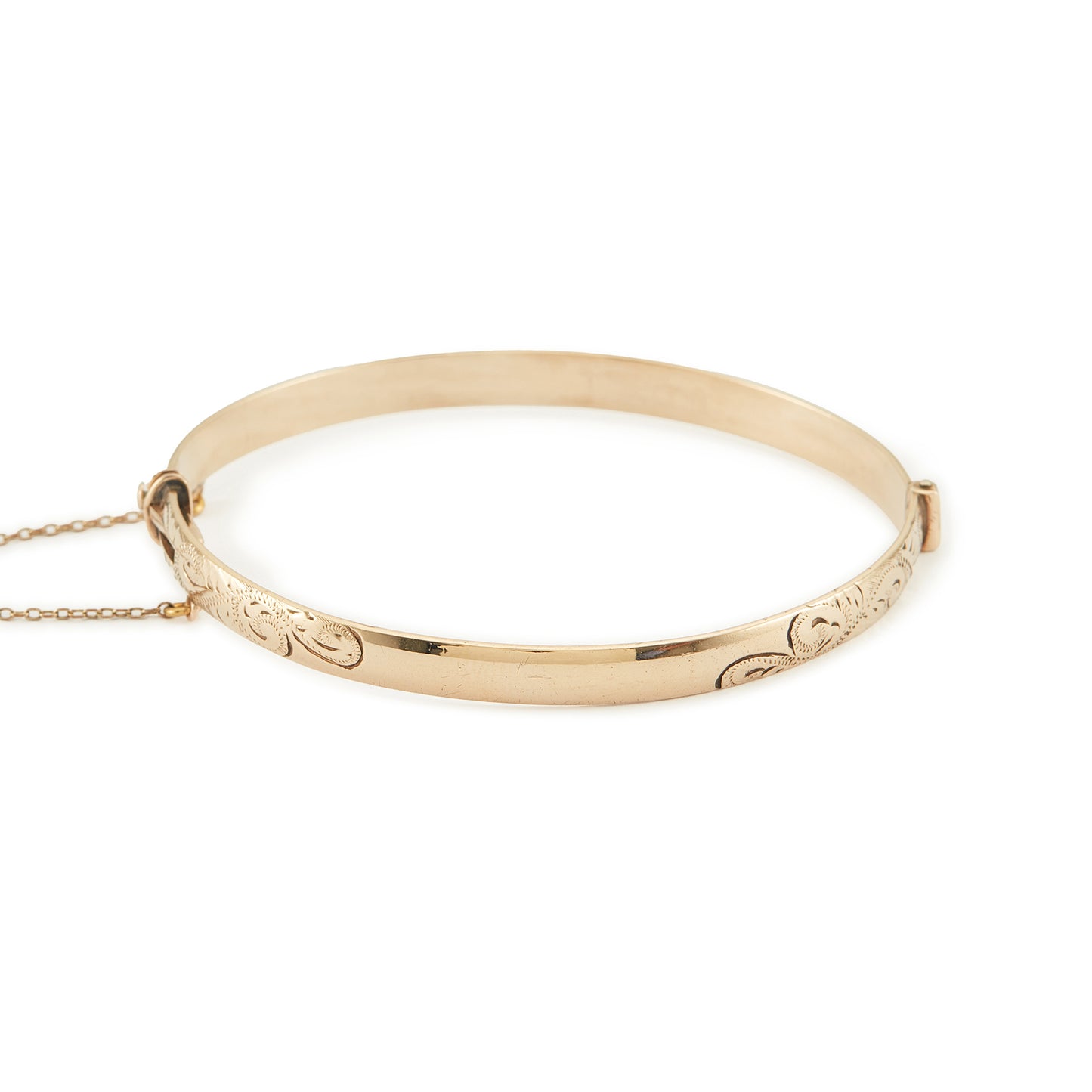 Beautifully engraved Edwardian 9ct gold bronze-core hinge bangle with a safety chain.
