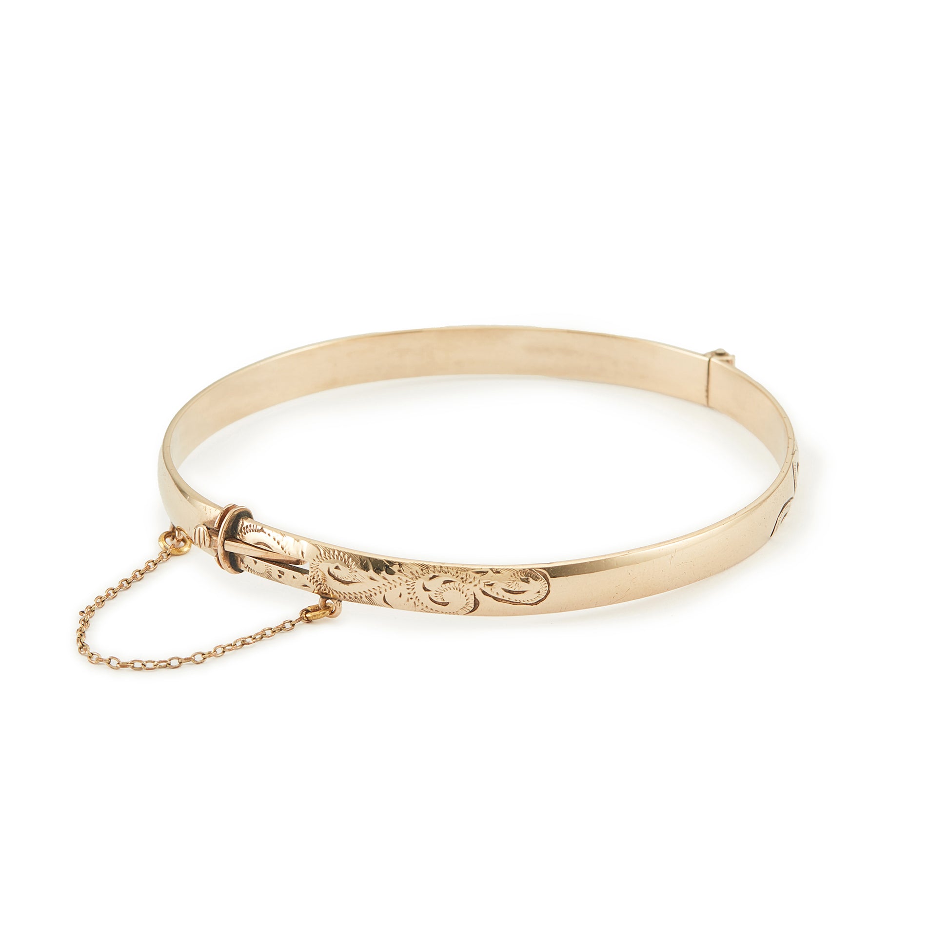 Beautifully engraved Edwardian 9ct gold bronze-core hinge bangle with a safety chain.