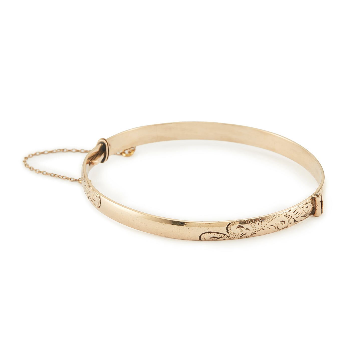Beautifully engraved Edwardian 9ct gold bronze-core hinge bangle with a safety chain.