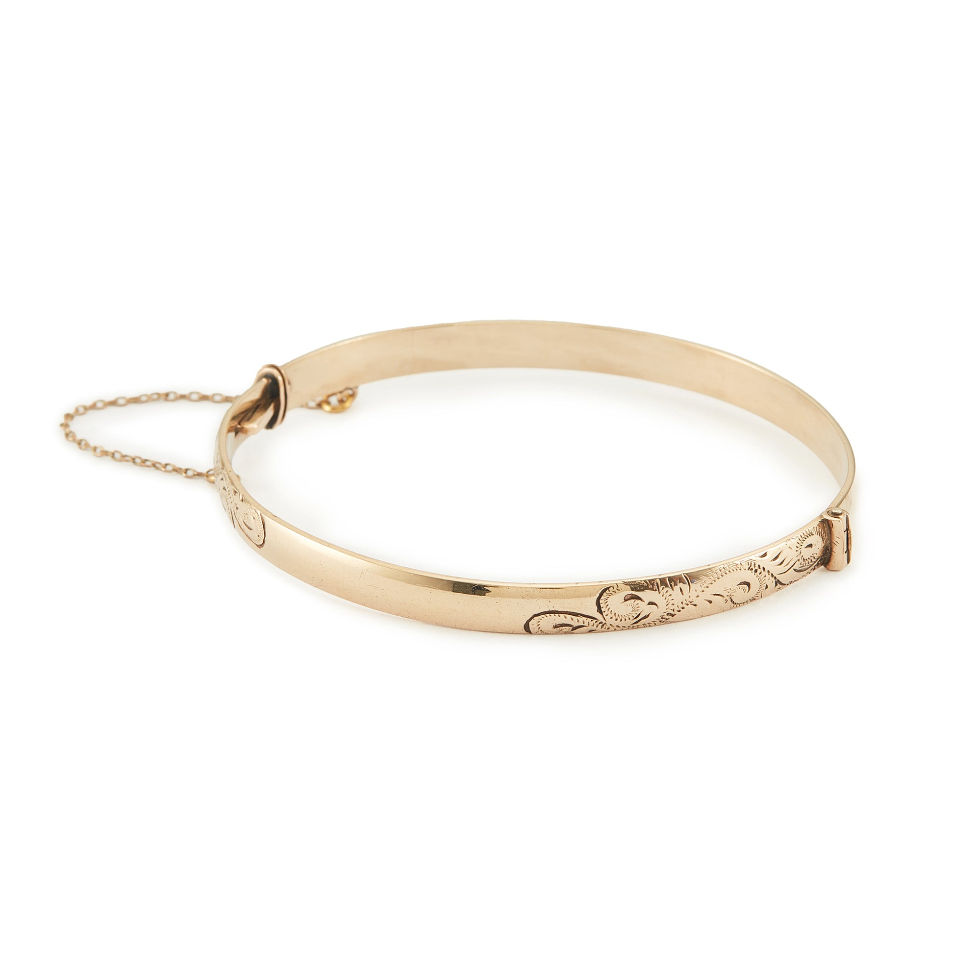 Beautifully engraved Edwardian 9ct gold bronze-core hinge bangle with a safety chain.