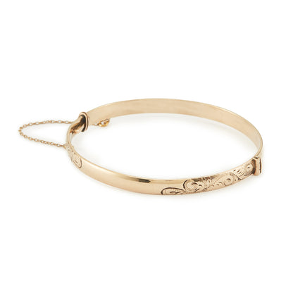 Beautifully engraved Edwardian 9ct gold bronze-core hinge bangle with a safety chain.