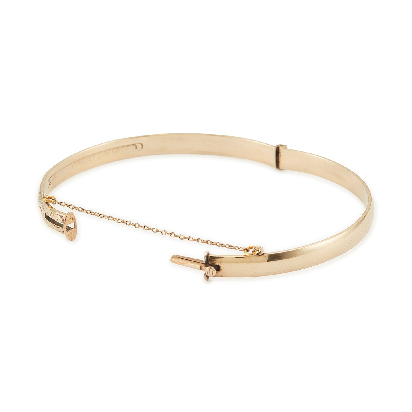 Beautifully engraved Edwardian 9ct gold bronze-core hinge bangle with a safety chain.