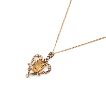 Gorgeous Edwardian 9ct gold pendant set with a beautiful cushion cut citrine surrounded by seed pearls. On a 9ct gold chain.