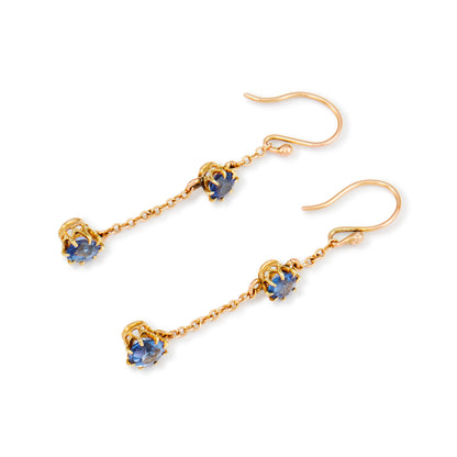 Exquisite 9ct gold Edwardian dangly earrings, each set with two beautifully faceted, cornflower blue sapphires.
