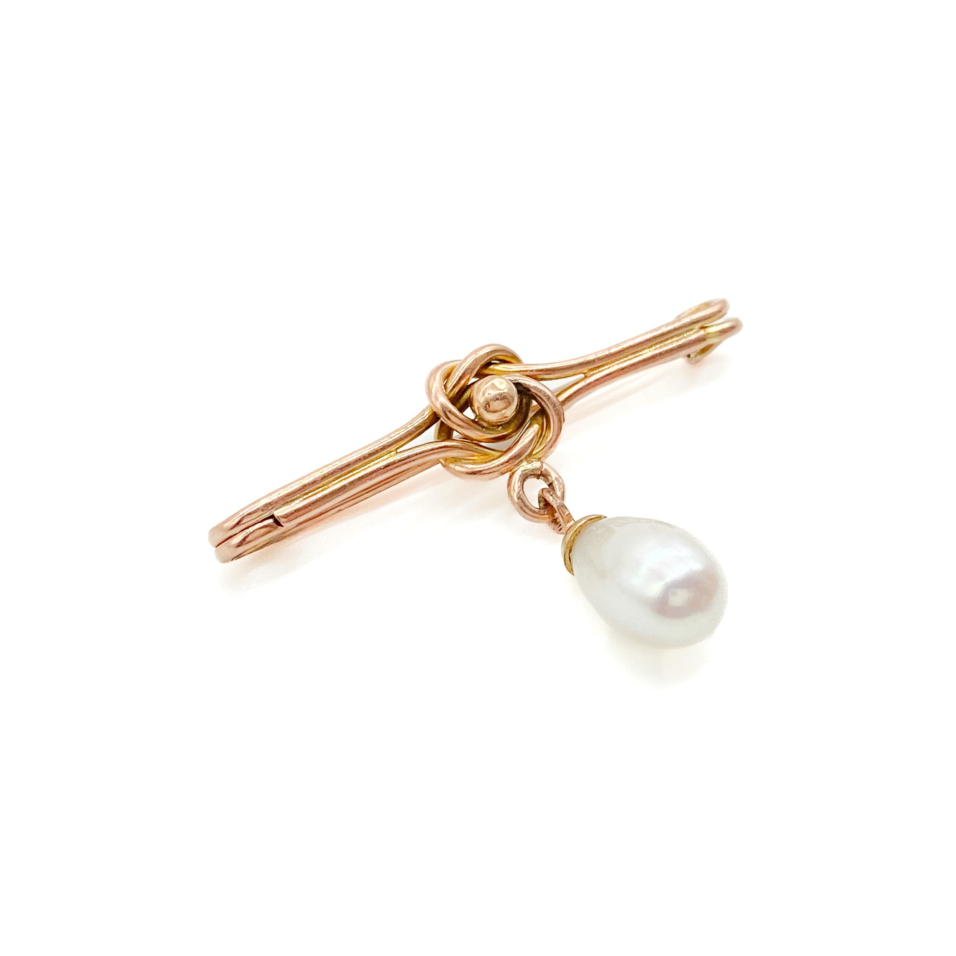 Classic Edwardian 9ct rose gold brooch with a celtic knot design and a dangling teardrop pearl.