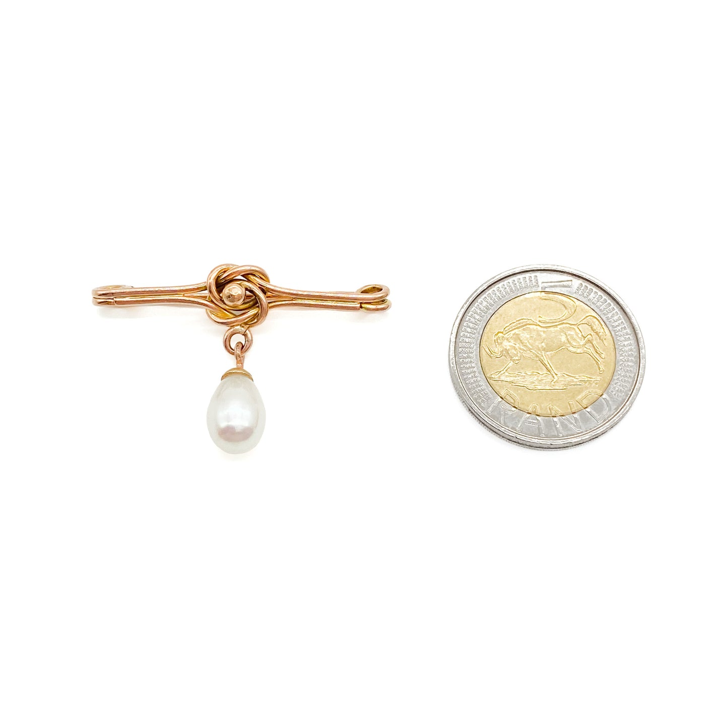 Classic Edwardian 9ct rose gold brooch with a celtic knot design and a dangling teardrop pearl.