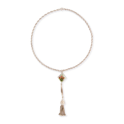 Pretty Edwardian silver albertina necklace with a beautifully enamelled diamond-shaped disc depicting a bouquet of flowers. The disc also has intricate floral engraving at the back. The albertina has a dangling tassel drop.