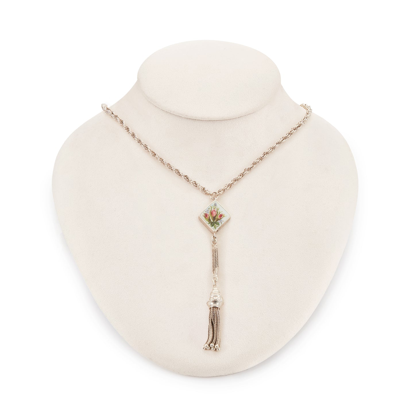 Pretty Edwardian silver albertina necklace with a beautifully enamelled diamond-shaped disc depicting a bouquet of flowers. The disc also has intricate floral engraving at the back. The albertina has a dangling tassel drop.