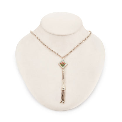 Pretty Edwardian silver albertina necklace with a beautifully enamelled diamond-shaped disc depicting a bouquet of flowers. The disc also has intricate floral engraving at the back. The albertina has a dangling tassel drop.
