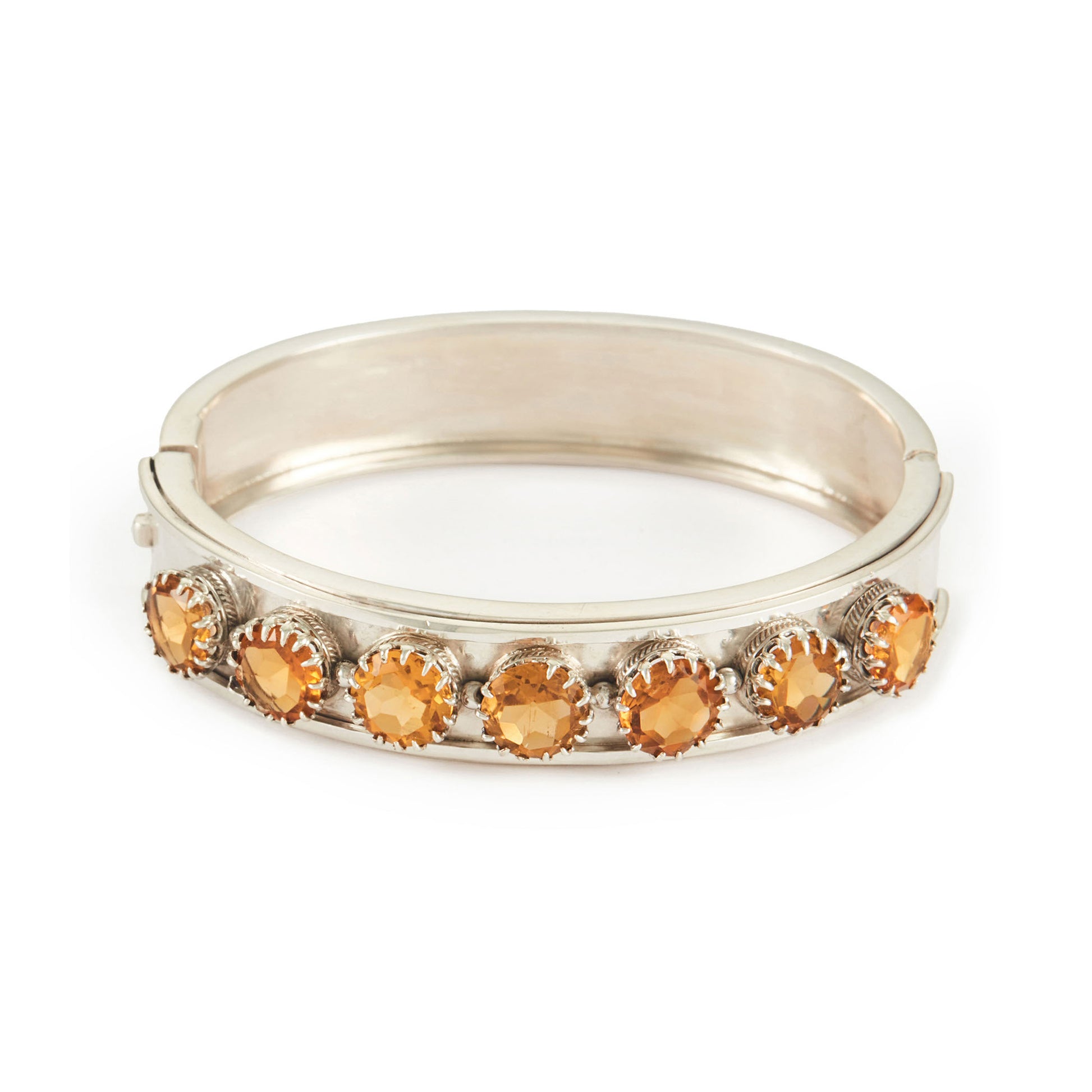 Elegant Edwardian silver bangle set with seven beautifully faceted champagne-coloured citrines.