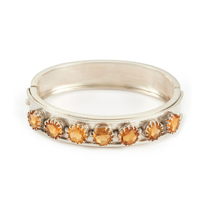Elegant Edwardian silver bangle set with seven beautifully faceted champagne-coloured citrines.