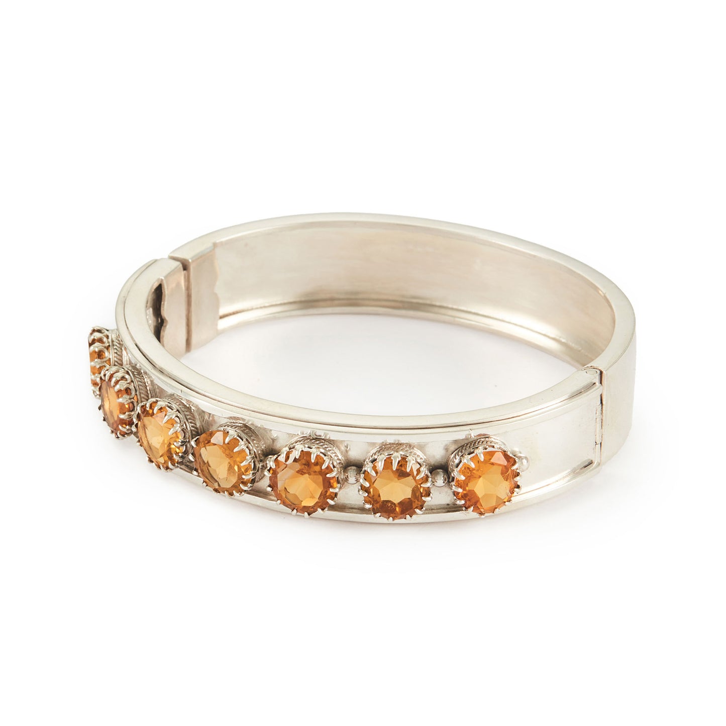 Elegant Edwardian silver bangle set with seven beautifully faceted champagne-coloured citrines.