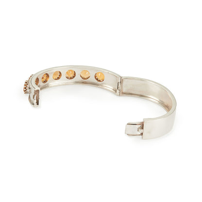 Elegant Edwardian silver bangle set with seven beautifully faceted champagne-coloured citrines.