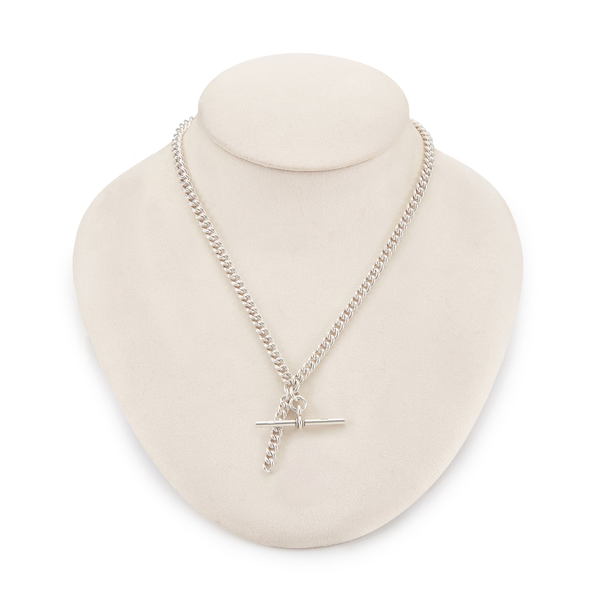 Classic Edwardian Sterling silver curb link fob chain with two dog-clips and a T-bar. There is a piece of chain attached allowing the chain to be lengthened or to attach a medallion or fob. Every link is stamped.