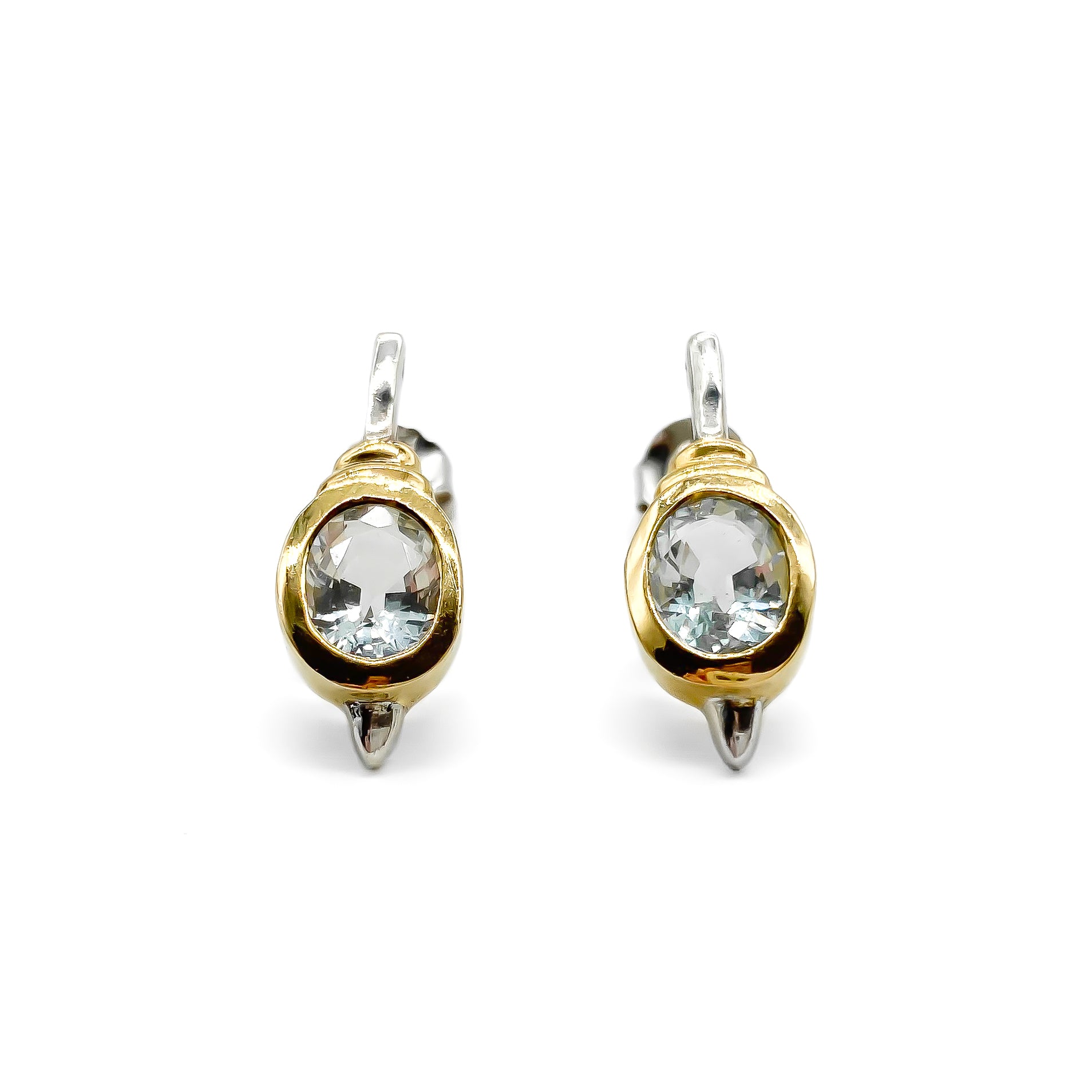 Classic gold on sterling silver drop earrings with tube set oval faceted aquamarine stones.