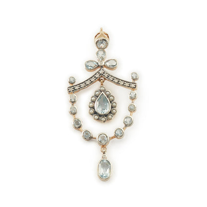 Pretty Edwardian-style gold on silver pendant set with seventeen light blue topaz stones, fifteen small diamonds and twelve tiny seed pearls.