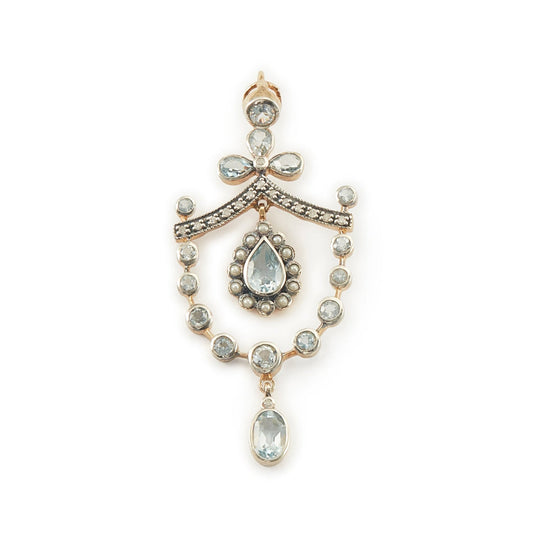 Pretty Edwardian-style gold on silver pendant set with seventeen light blue topaz stones, fifteen small diamonds and twelve tiny seed pearls.