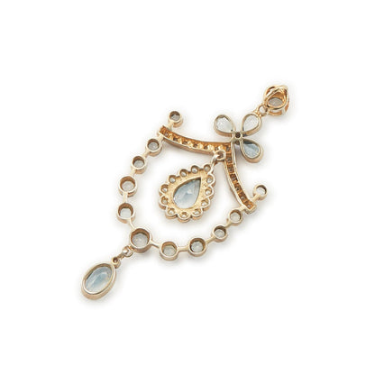 Pretty Edwardian-style gold on silver pendant set with seventeen light blue topaz stones, fifteen small diamonds and twelve tiny seed pearls.
