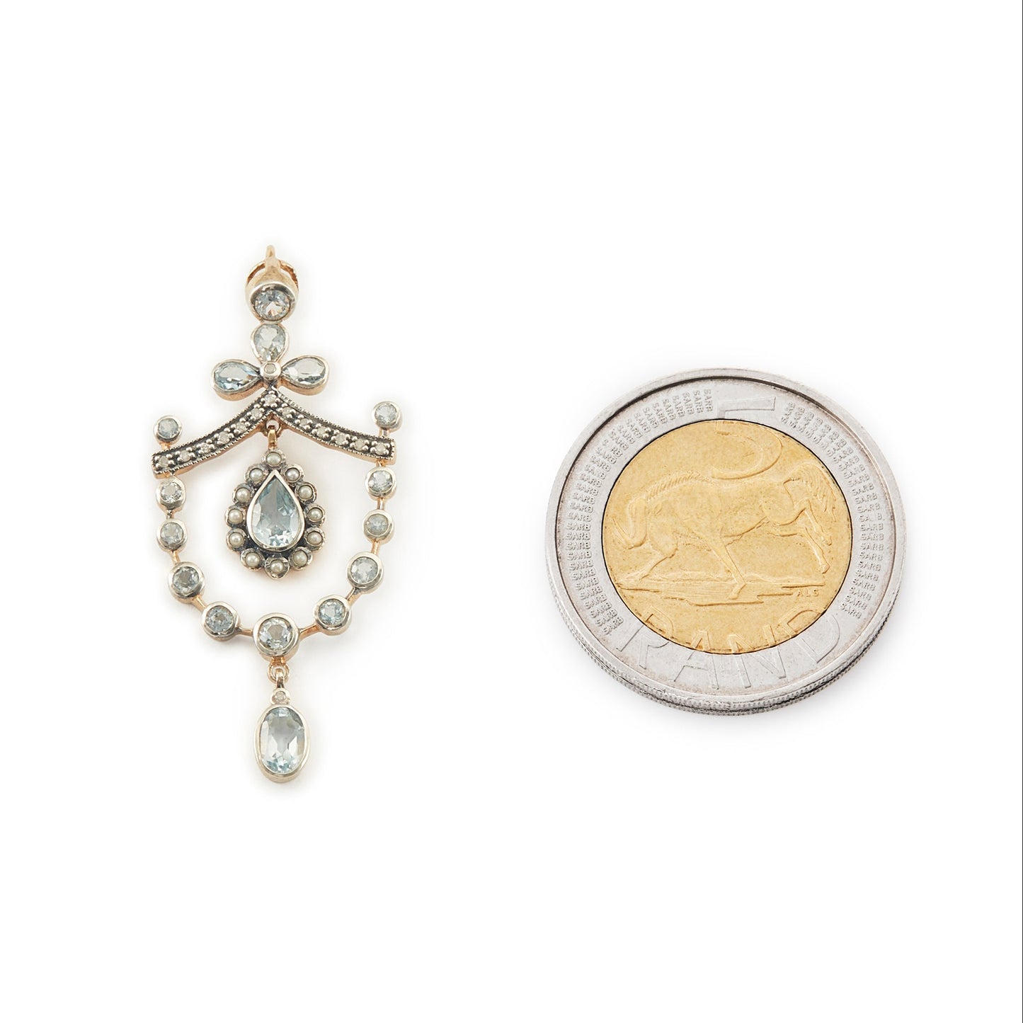 Pretty Edwardian-style gold on silver pendant set with seventeen light blue topaz stones, fifteen small diamonds and twelve tiny seed pearls.