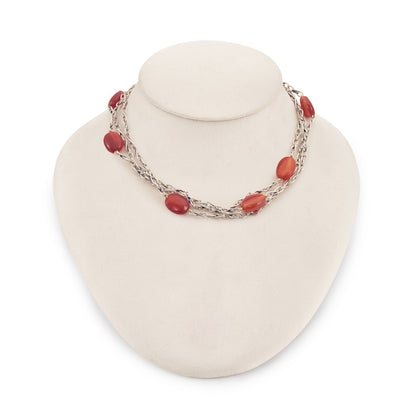 Elegant sterling silver fancy link chain interspersed with seven carnelian stones. Long enough to drape around the neck twice.