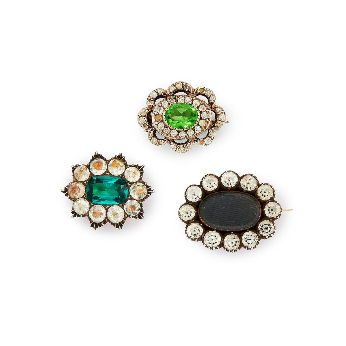 Lot of three quaint silver/gold on silver Victorian miniature brooches set with green and white paste stones, and plaited hair (mourning brooch on bottom right). Lovely to be worn as a group or individually.