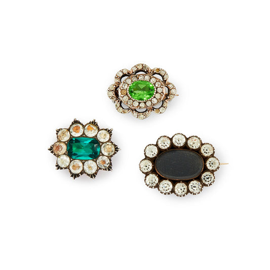 Lot of three quaint silver/gold on silver Victorian miniature brooches set with green and white paste stones, and plaited hair (mourning brooch on bottom right). Lovely to be worn as a group or individually.