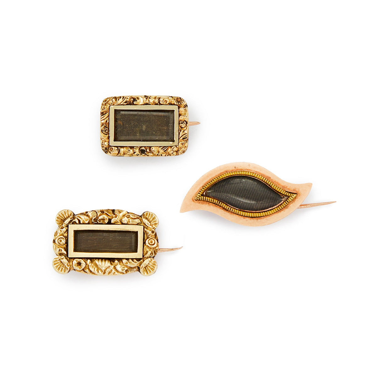 Lot of three exquisite gold/gold-cased miniature Victorian mourning brooches with plaited hair and intricate engraving. Lovely to be worn as a group or individually.