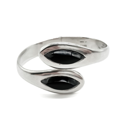 Classic sterling silver Mexican clamper bangle with two faceted onyx stones.