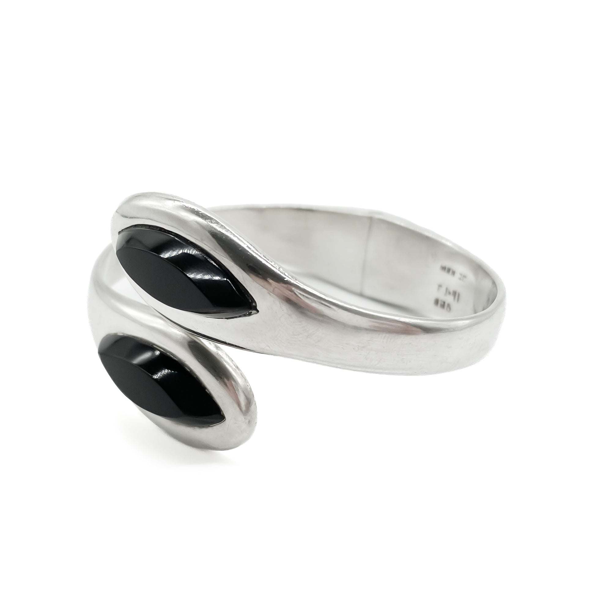 Classic sterling silver Mexican clamper bangle with two faceted onyx stones.