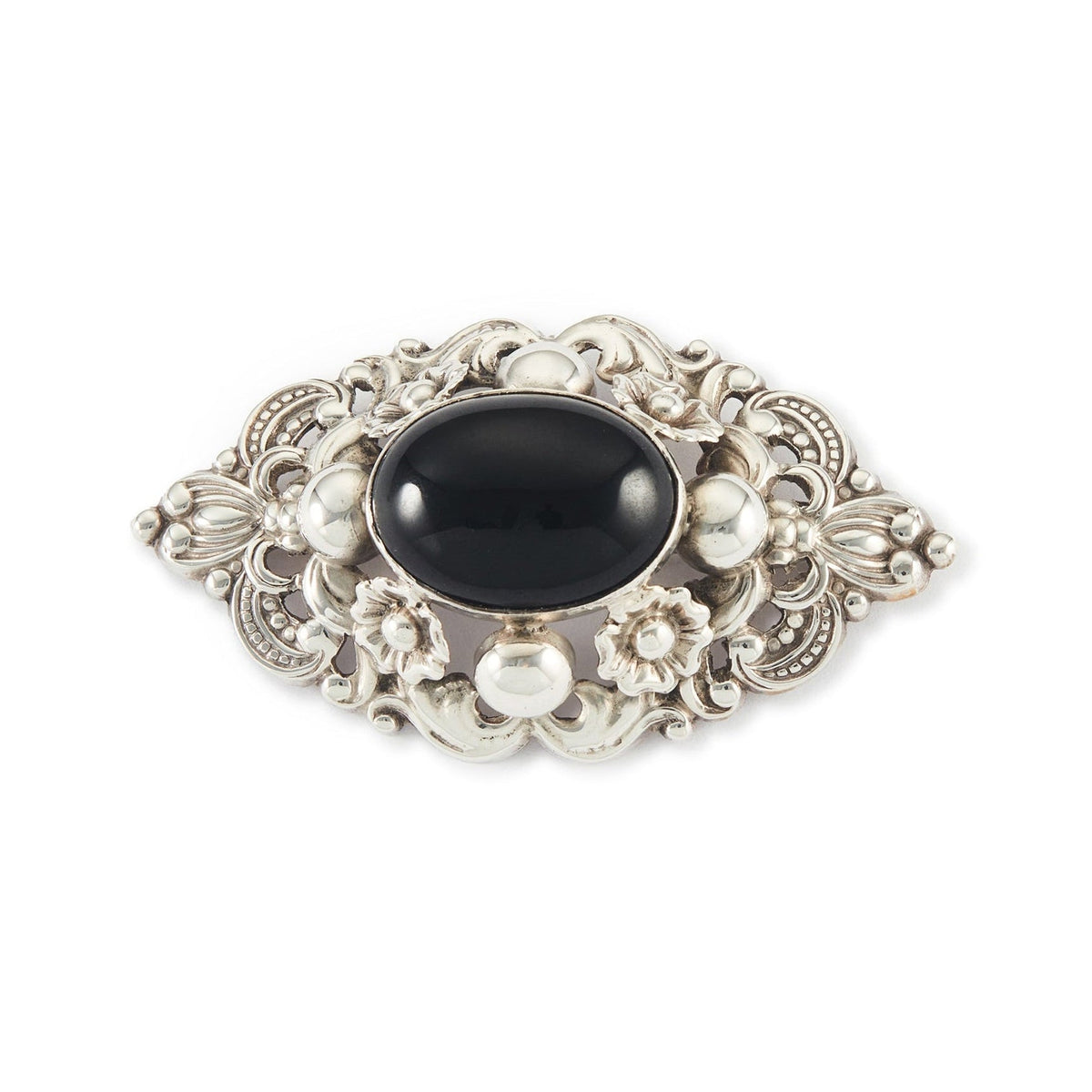 Ornate Mid-Century sterling silver Candida brooch set with an onyx cabochon stone, surrounded with a repoussé design. South Africa