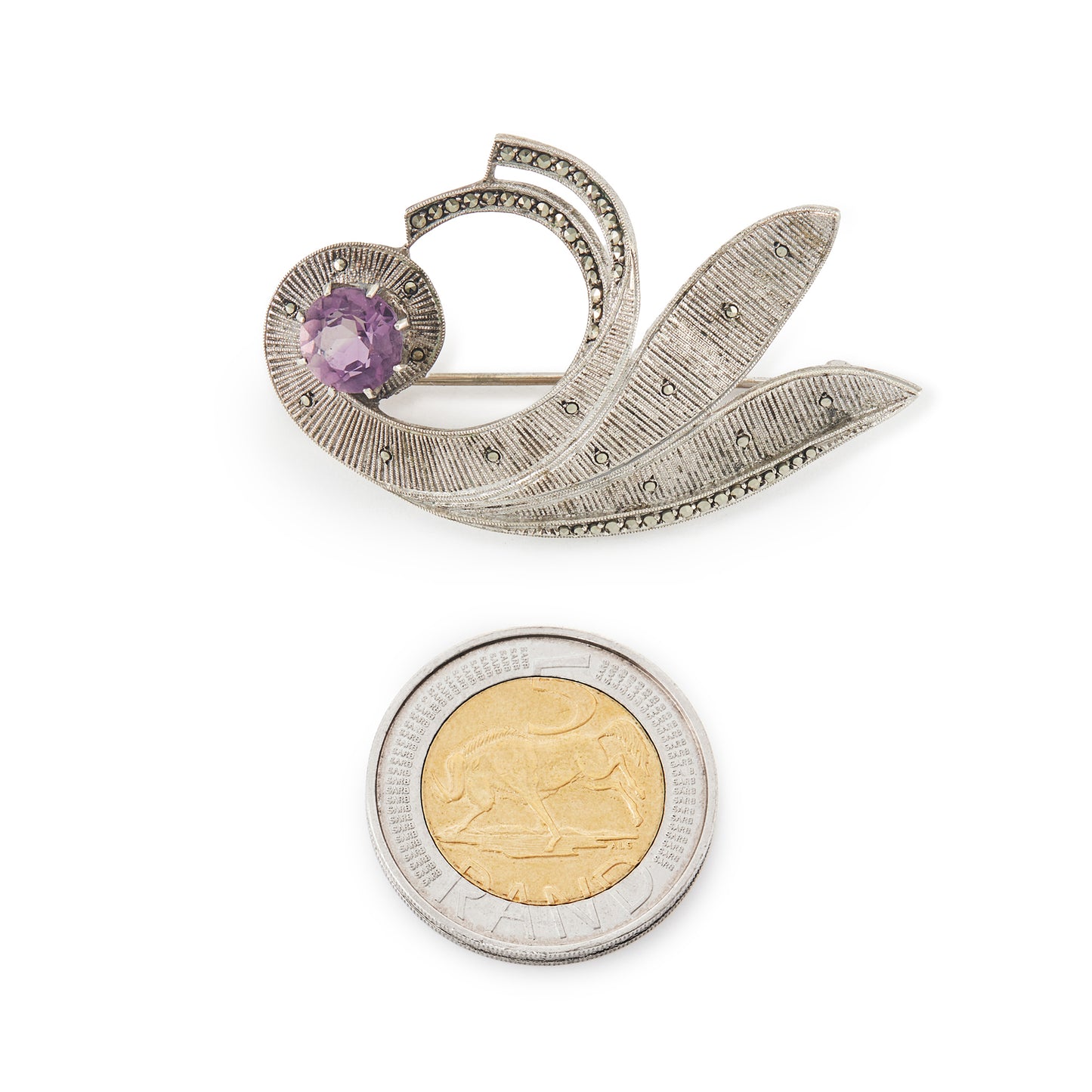 Stylish mid-century sterling silver Theodor Fahner brooch set with a vibrant, faceted amethyst and marcasites. Germany