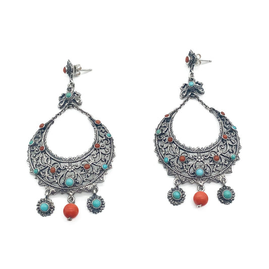 Large, ornate silver drop earrings set with coral and turquoise. Zoltan White and Co.