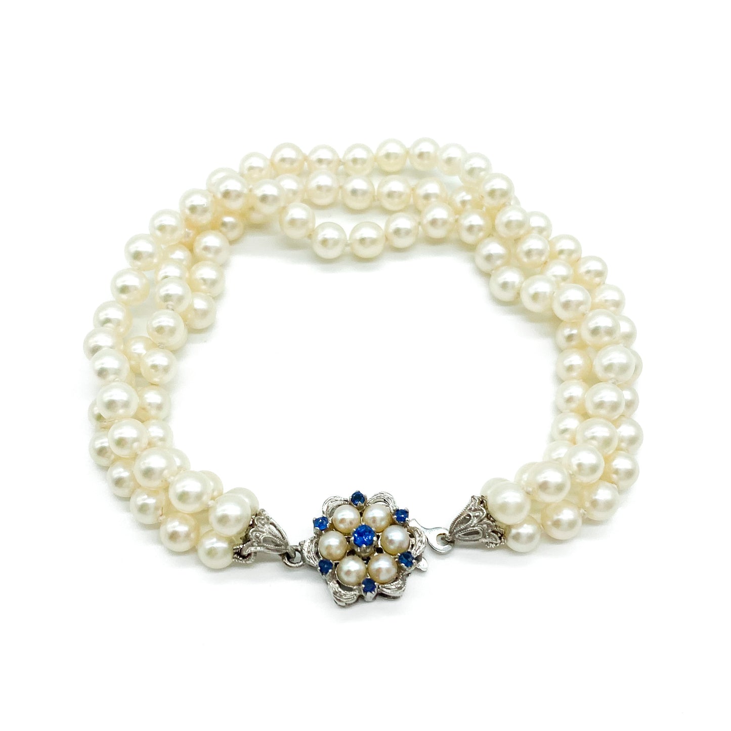 Pretty vintage three strand cultured pearl bracelet with an exquisite 18ct white gold sapphire and pearl clasp.