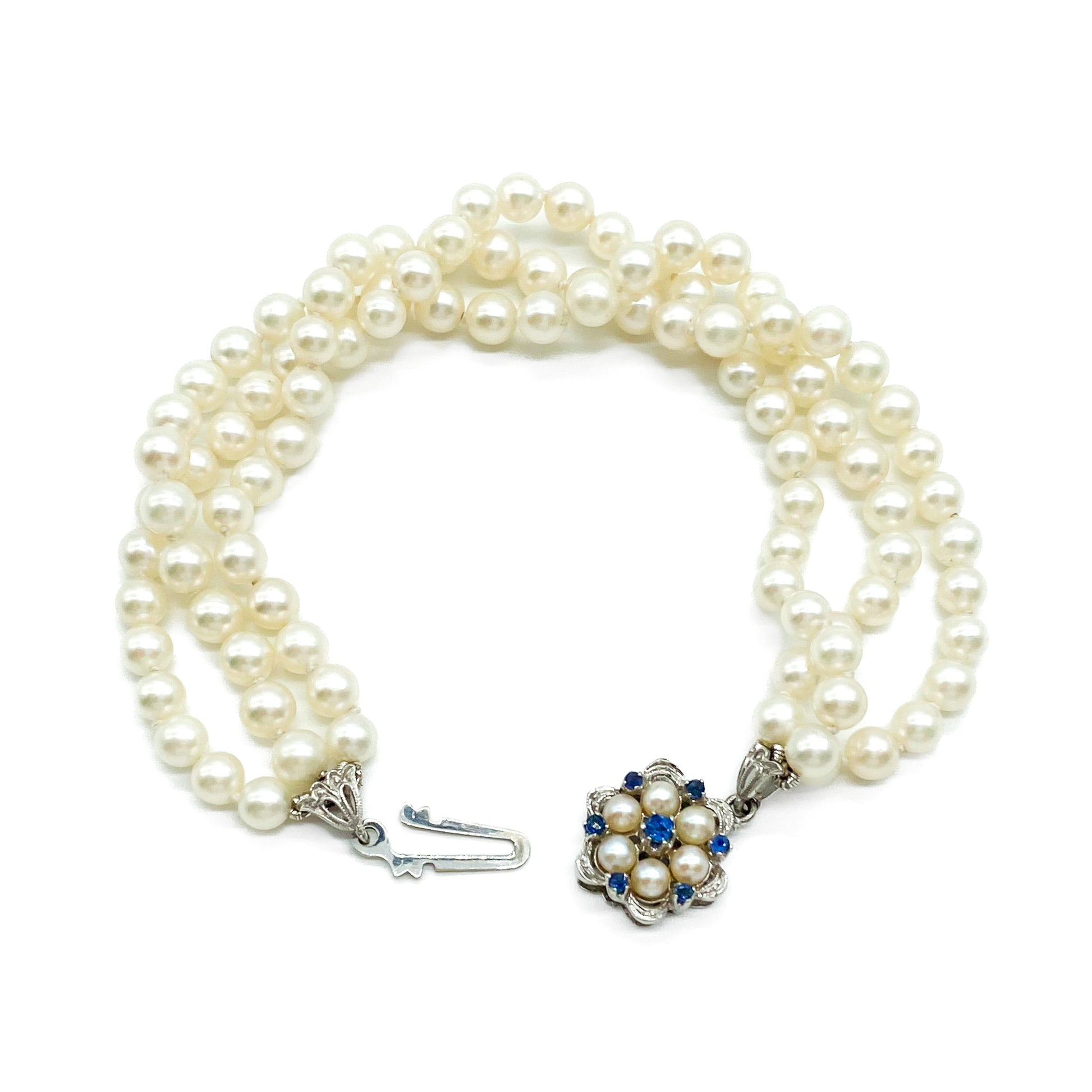 Pretty vintage three strand cultured pearl bracelet with an exquisite 18ct white gold sapphire and pearl clasp.