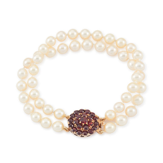Exquisite double-strand seawater pearl bracelet with a stunning 9ct gold clasp set with twenty-two deep red garnets.