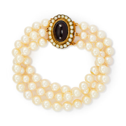 Glamorous three strand cultured seawater pearl bracelet with a spectacular Victorian 9ct gold cabochon garnet and seed pearl clasp.
