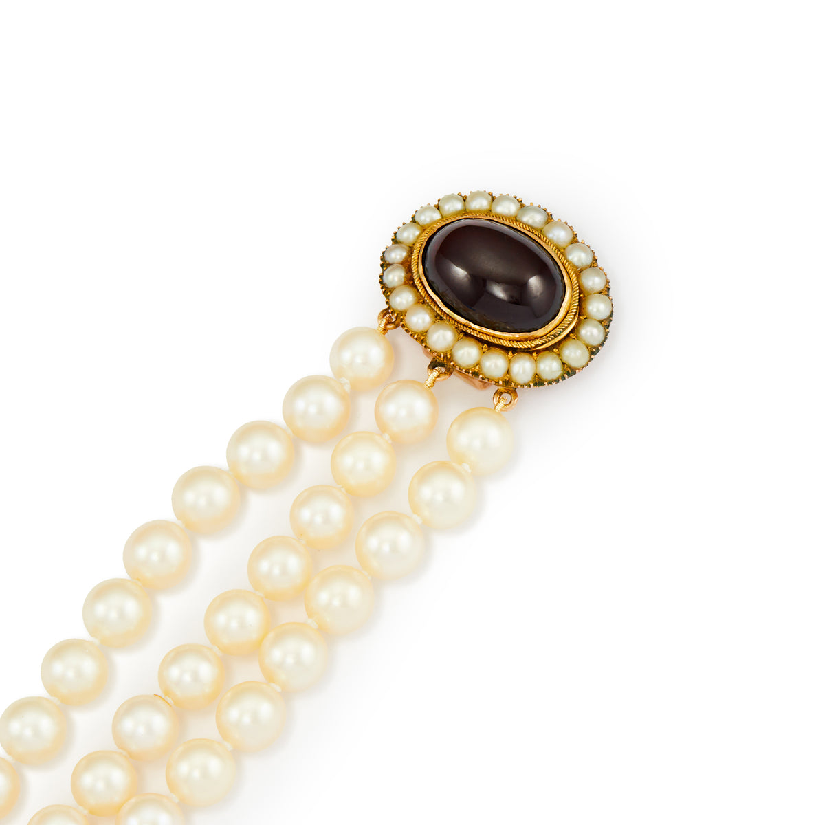 Glamorous three strand cultured seawater pearl bracelet with a spectacular Victorian 9ct gold cabochon garnet and seed pearl clasp.